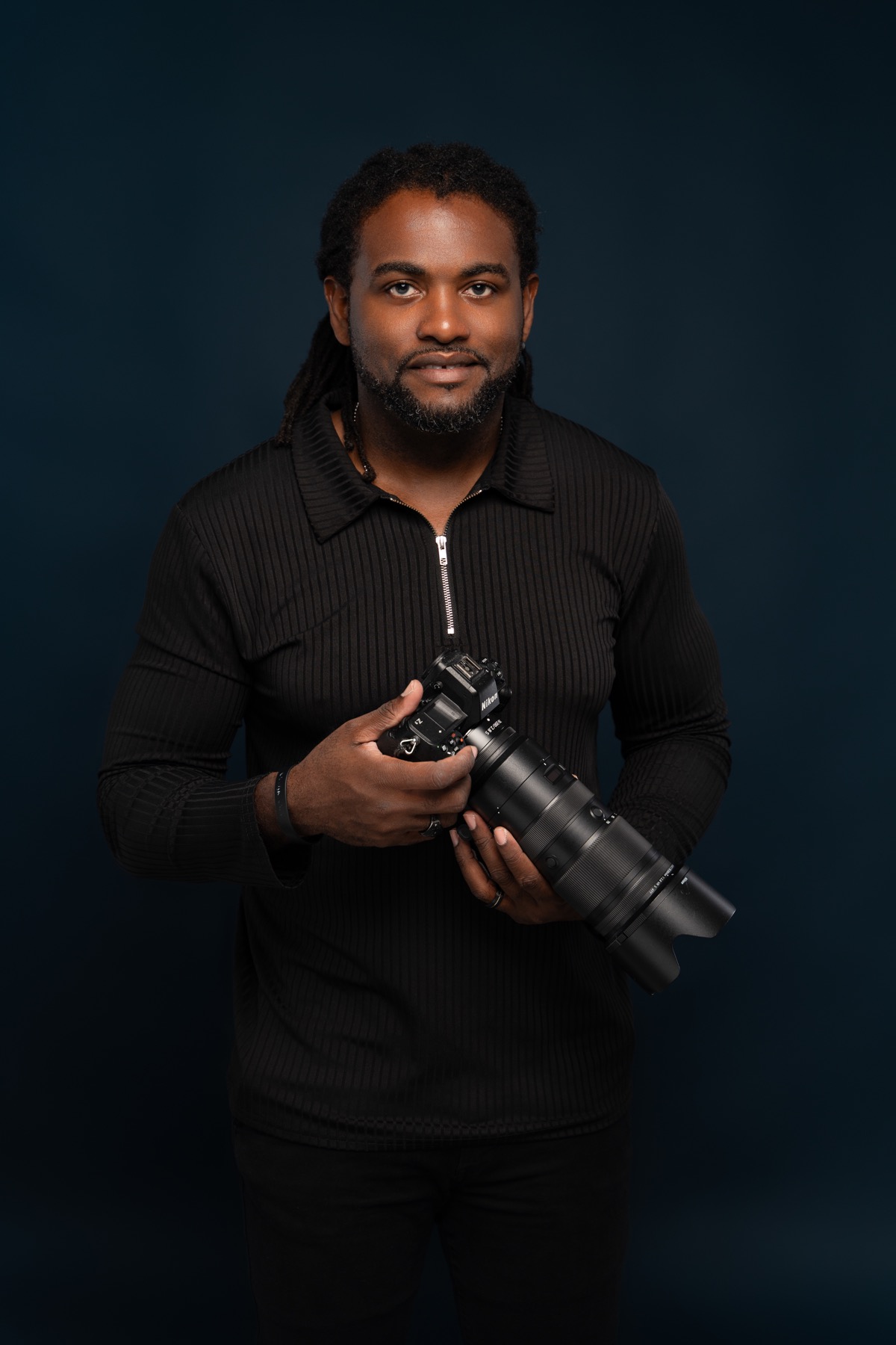 Portrait of Gladstone Taylor holding a camera